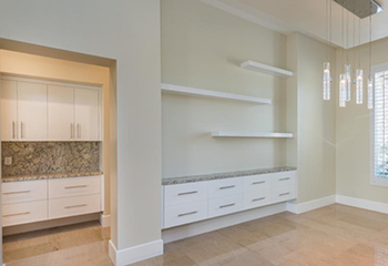 The master bedroom has a stylish ceiling design, a modern light fixture, and a sleek, built-in closet.